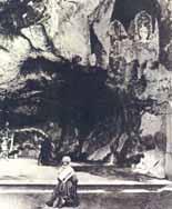 A historical image showing the Sanctuary of Lourdes with a figure in the foreground.