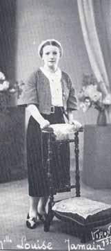 Louise Jamain, cured of pulmonary and intestinal tuberculosis during the Eucharistic procession at Lourdes, stands beside a chair.