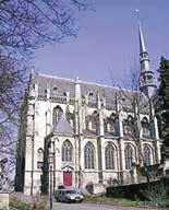 A side view of the Basilica of the Blessed Sacrament in Meerssen, showcasing its architectural features.