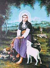 A young girl in traditional attire sits with a lamb in a pastoral setting.