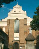 A church facade with a large central window and decorative architectural elements.