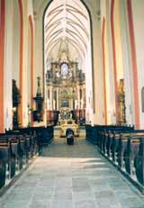 The interior of the shrine where the miraculous Hosts were preserved, featuring pews and an ornate altar.