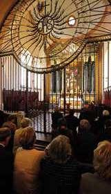 View of the altar area with attendees in a church setting.