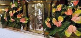 Tabernacle where the miraculous Host that fell to the ground was first stored, adorned with vibrant floral arrangements.