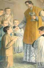 A priest in a golden vestment distributes communion to a young boy surrounded by other children.