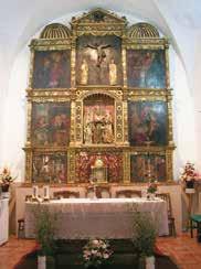 An ornate altar with religious paintings and a central crucifix.