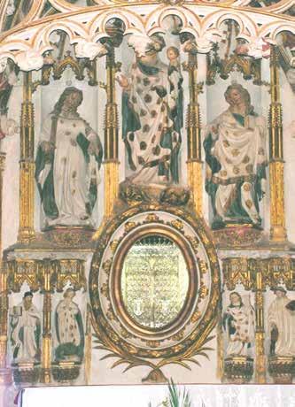 The image shows a decorated chapel with figures and an ornate circular mirror.
