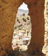 Panoramic view of Daroca through a stone arch, symbolizing the hidden Hosts during the 1239 miracle.