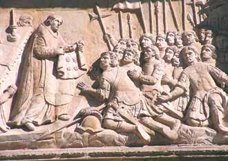 A relief depicting a priest with soldiers, illustrating a historical Eucharistic miracle.