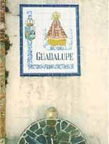 Decorative tile mural depicting 'Guadalupe' and religious imagery, linked to the 1420 Eucharistic miracle in Spain.