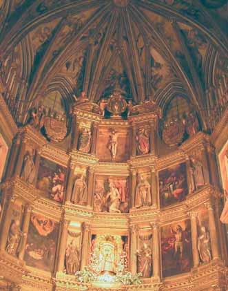 Interior view of a church with ornate decorations and religious paintings on the walls.