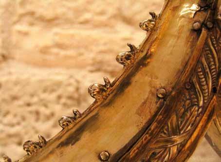 Close-up of the ornate edge of a golden relic frame.
