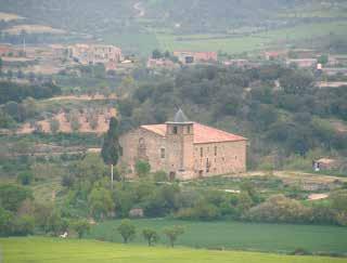 A stone sanctuary surrounded by greenery and hills, depicting the site of a historical miracle.