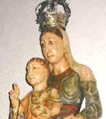 A statue of the Madonna holding the child Jesus, adorned with a crown.