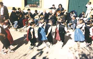 Children and adults dance during 'la Pedrera' feast, celebrating the miraculous recovery of the Host in Onil, 1824.
