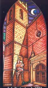 A stained glass depiction of St. James Church with a moonlit sky.