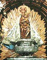Statue of the Virgin Mary with a radiant halo and ornate details.