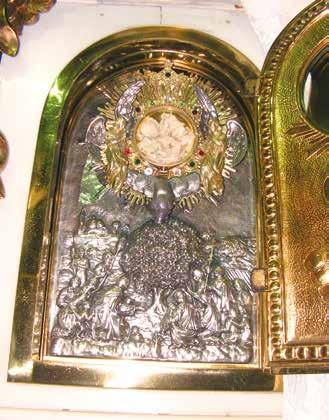 A golden reliquary containing the miraculous Hosts, adorned with intricate designs and figures.