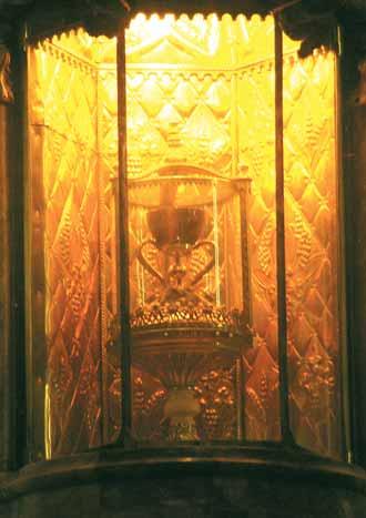 The Holy Chalice of Valencia, encased in ornate glass, symbolizes the 1055 Eucharistic miracle strengthening faith in transubstantiation.