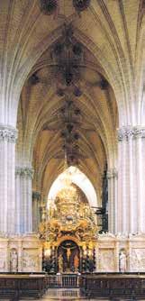 Interior view of a church with ornate architecture and an altar.