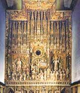 The ornate main altar featuring intricate carvings and religious figures.